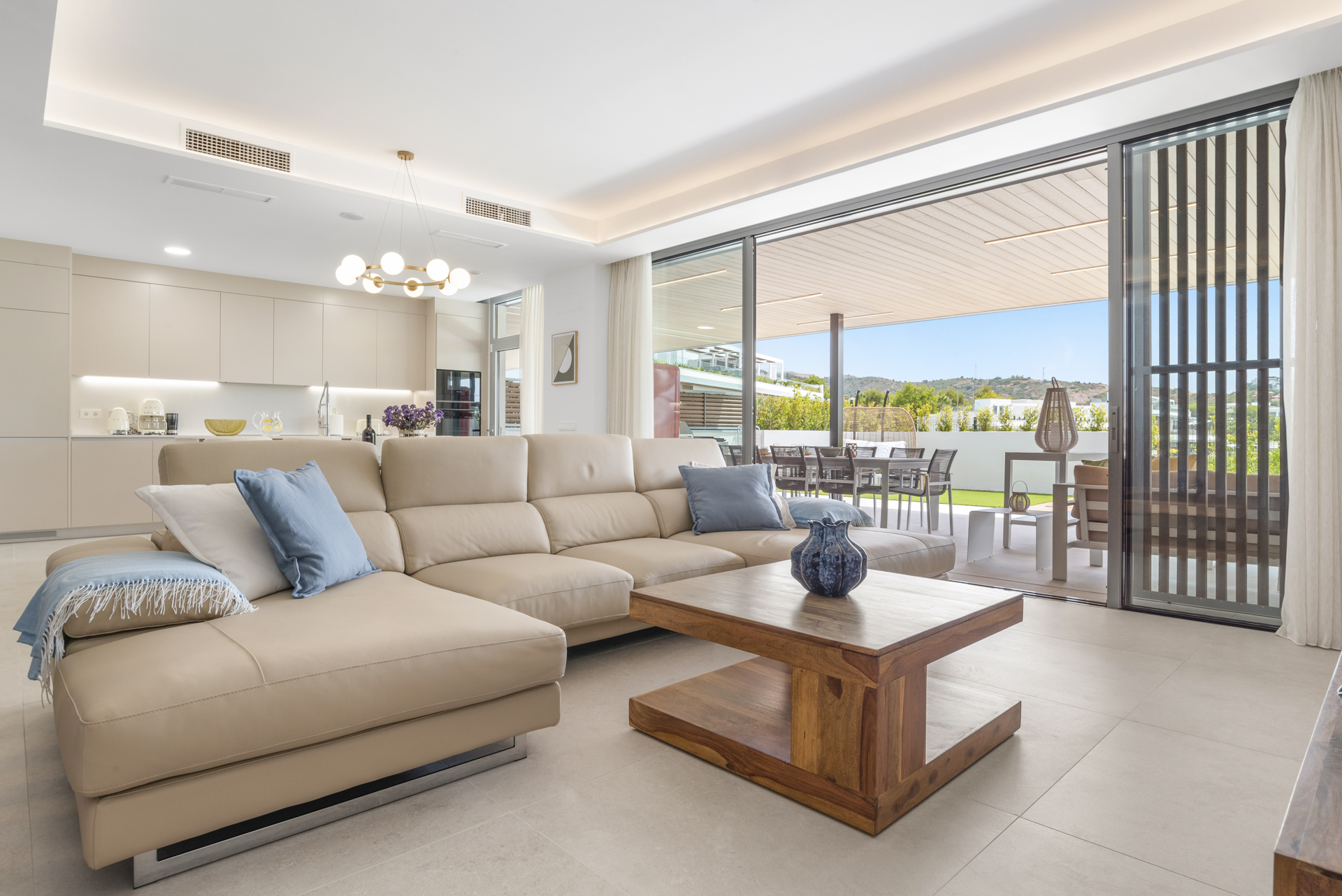 Open-plan living room opening onto the terrace at a Santa Clara apartment, Marbella